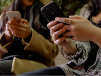 Two women using their smart phones