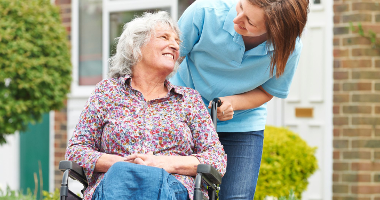 An elderly person and a carer 