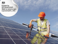 A person installing solar panels on a roof