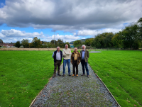 Image of four men standing at the new extension in Hay on Wye cemetery