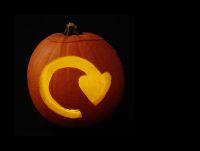 Image of a pumpkin carved with a recycling icon