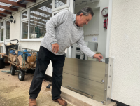 Tony Thorn with one of the flood defences installed to protect the doors to his home at Caersws.