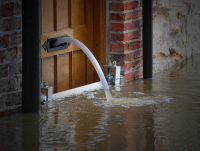 Water being pumped out of a flooded home