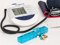 Image of a blood pressure monitor and some tablets